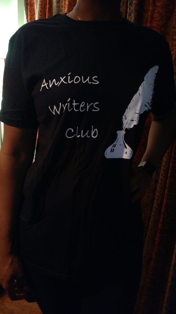 Cara in a black shirt that says Anxious Writers Club in White lettering